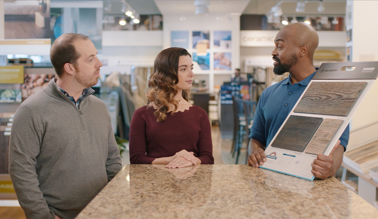 Couple Looking at Flooring with Sales Professional